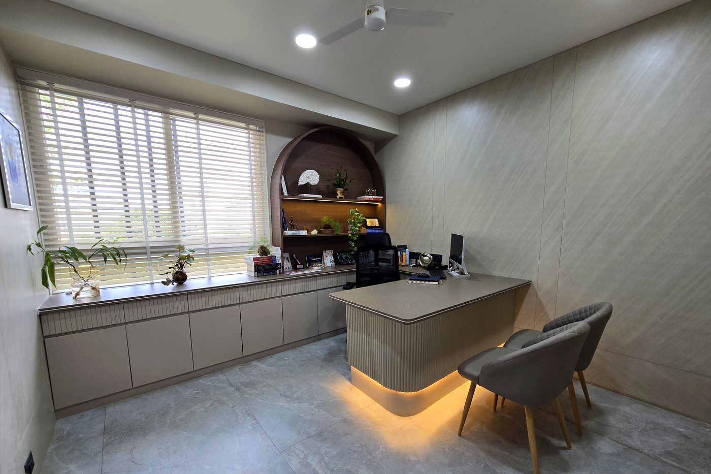 Aesthetic consultation suite with arched wood niche and back-lit shelving, Eternis Clinic Pune